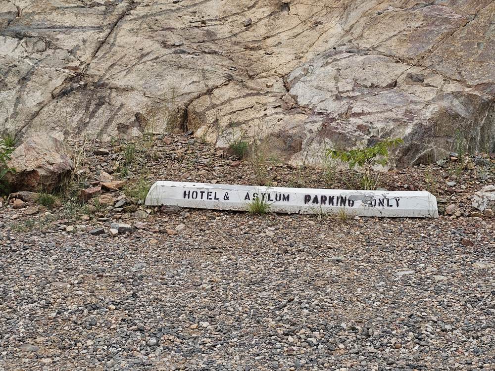 Painted curb reading Hotel and Asylum Parking Only