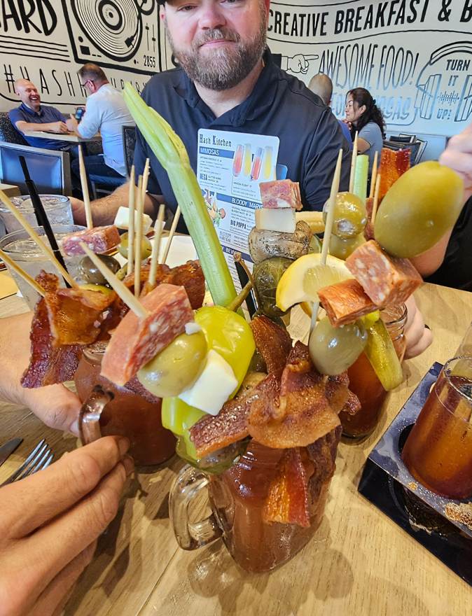 Bloody marys stacked with bacon and garnish towers