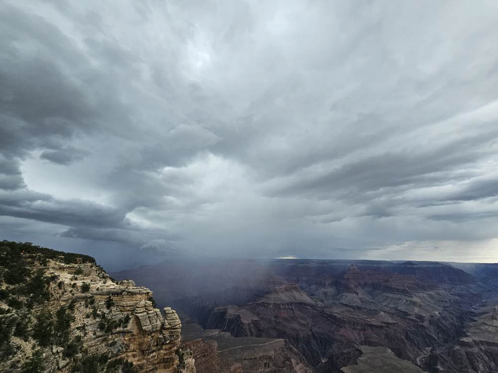 A curtain of monsoon rain advancing across the canyon